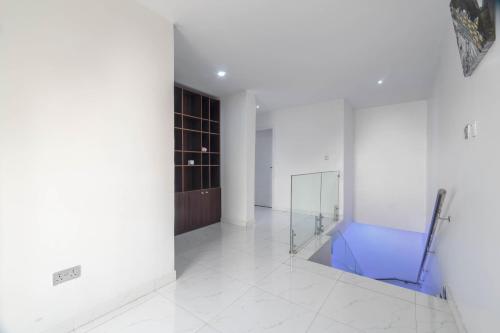 a white room with a glass shower in it at Gorgeous Short-let Apartment Lekki in Lekki