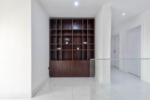 a room with a wooden closet with flowers in it at Gorgeous Short-let Apartment Lekki in Lekki