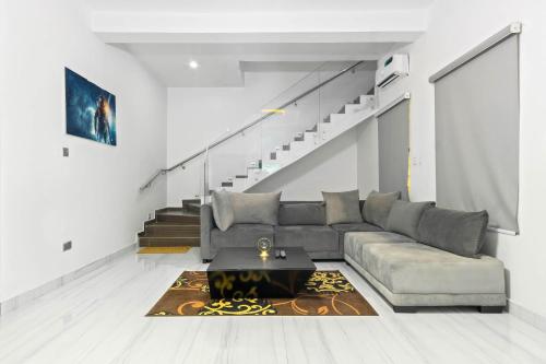 a living room with a couch and a table at Gorgeous Short-let Apartment Lekki in Lekki