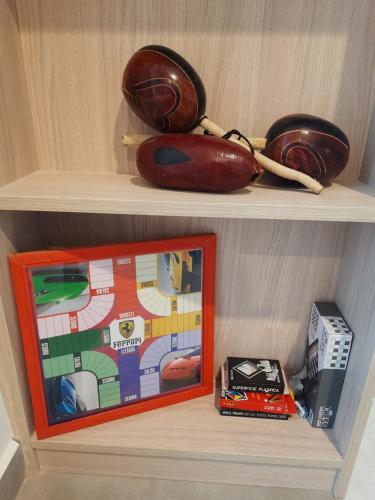 a shelf with a toy and a box on it at El Samario Cumbia Host-Playa Salguero- Santa Marta in Gaira