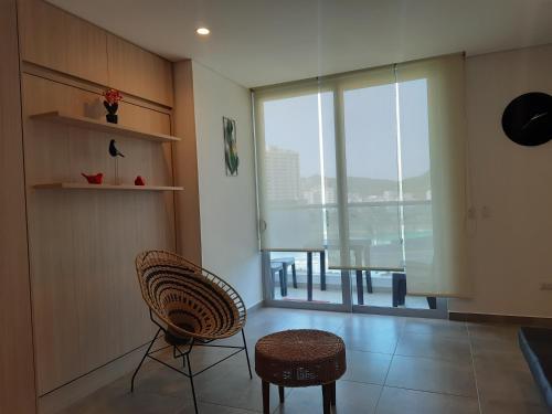 a room with two chairs and a large window at El Samario Cumbia Host-Playa Salguero- Santa Marta in Gaira