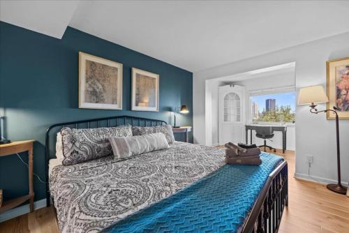 a bedroom with a bed with a blue wall at Stunning views from stylish 3-bedroom home in Pittsburgh