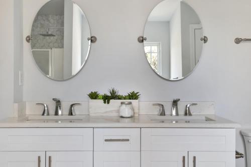 a white bathroom with two sinks and a mirror at Zen Home in the Heart of Atlanta in Atlanta