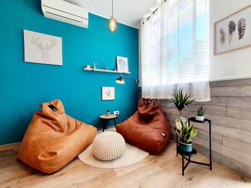 a living room with two ottomans at Harmony - Your Cozy Retreat a Short Walk from the Center in Portorož