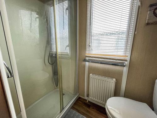 a bathroom with a shower and a toilet at Modern 6 Berth Caravan At Martello Beach In Essex Ref 29002sv in Clacton-on-Sea