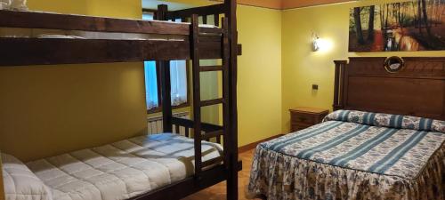 a bedroom with two bunk beds and a bed at Hotel Rural Bereau in Lesaka