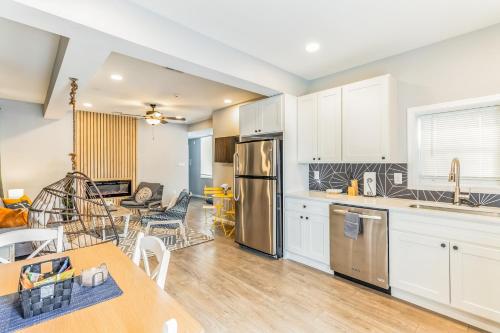 a kitchen and living room with white cabinets and a table at Shops, Dave and Busters and Convention Center across street! U1 in Atlantic City