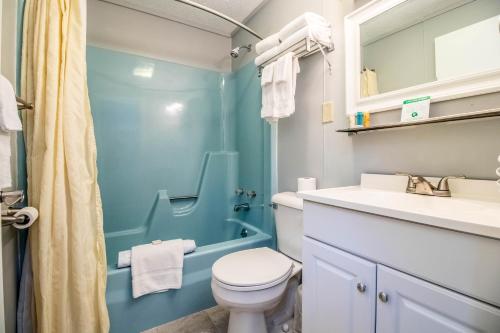 a bathroom with a toilet and a sink and a shower at Sea View Motel in Ogunquit