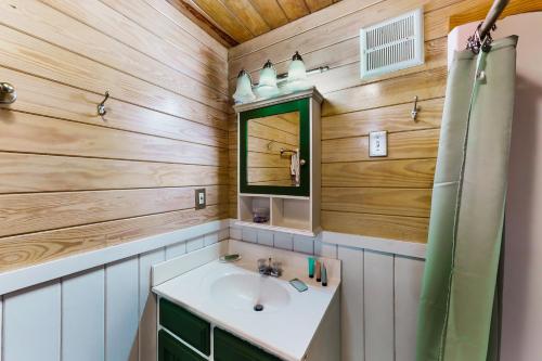 a bathroom with a sink and a mirror at New Kids On The Dock in Destin