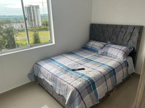 a bed in a room with a window at Confortable apto en Armenia 1505 in Armenia