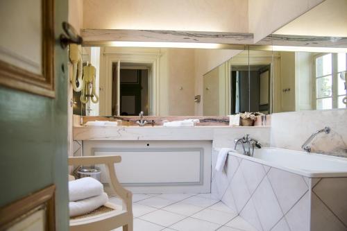 a bathroom with two sinks and a large mirror at Malouinière Le Valmarin in Saint Malo