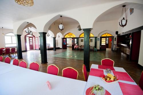 a dining room with a table and chairs and a room at Marysieńka in Kwatoniów