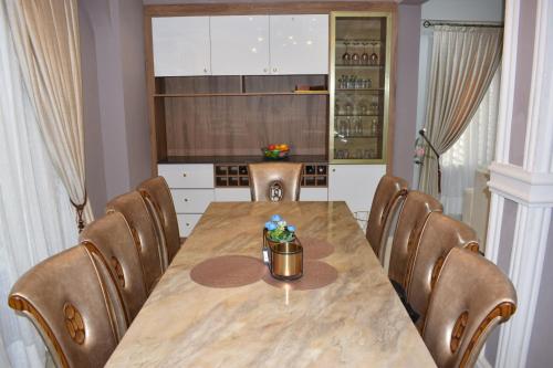 a dining room with a table and chairs at Boulevard Court in Ejisu