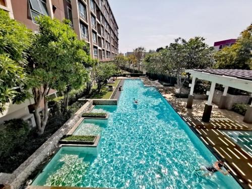 a swimming pool with blue water in a building at Baan Peang Ploen Hill View 7th floor in Hua Hin