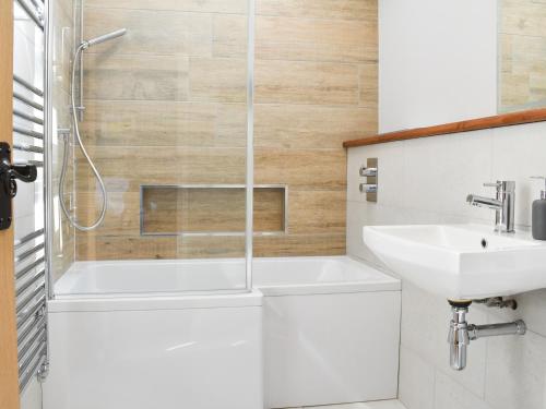 a bathroom with a shower and a sink at White Heather Barn in Swanwick