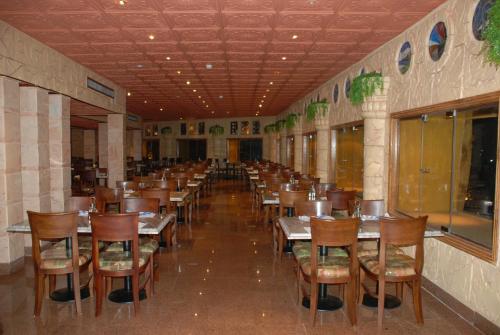 a row of tables and chairs in a restaurant at Happy Life Village Dahab in Dahab