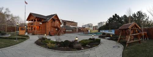 a playground with a wooden house at VVP Club Hotel in Tiraspol