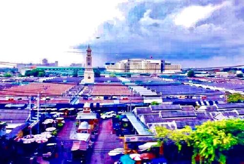 a large parking lot with a lighthouse in a city at VR hostel สะพานควาย in Bang Su