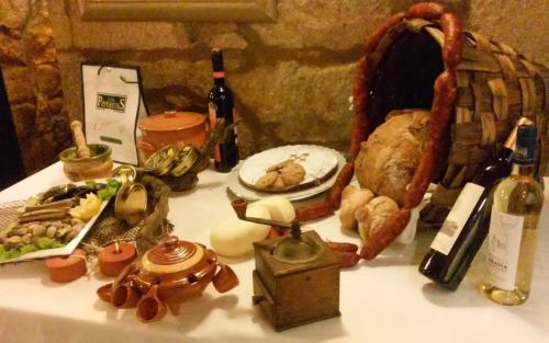 a table with food and bottles of wine on it at Hotel Gastronómico Casa Rosalia in Brion