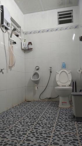 a bathroom with a toilet and a sink at Amikaje Farm in Xuan An