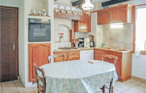 a kitchen with a table and a table and chairs at Holiday Home Menez Rooz - 01 in Pont-lʼAbbé