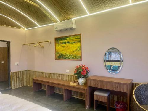 a room with a bench and a mirror at Sapa Bamboo Eco in Sa Pa