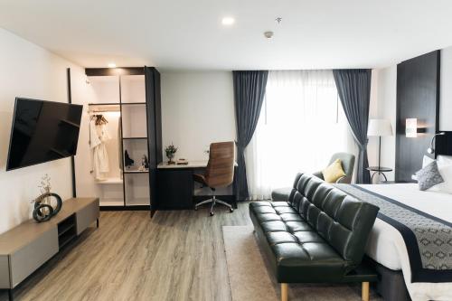 a hotel room with a bed and a couch at SureStay Hotel by Best Western Vientiane in Vientiane