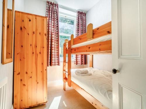 a bedroom with two bunk beds and a window at Greenbank in Keswick
