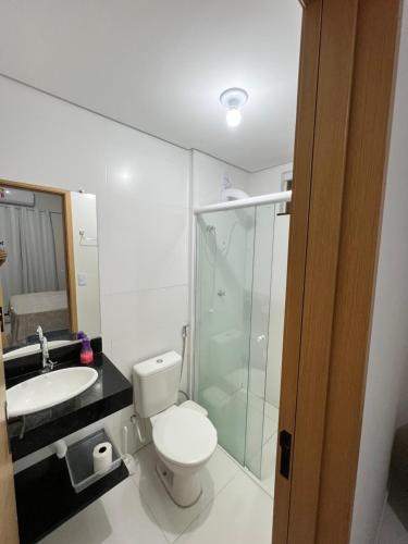 a bathroom with a toilet and a sink and a shower at Lençóis Confort - BL05-AP02 in Barreirinhas