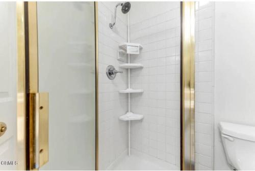 a shower with a glass door next to a toilet at Contemporary Zen Place - Entire First Floor in Thousand Oaks