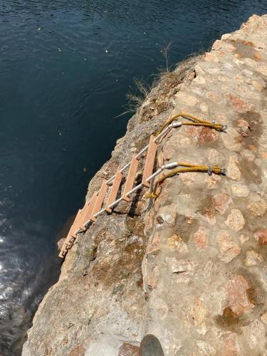 a brick wall next to a body of water at RiverHill Hideaway in Monkey Fall