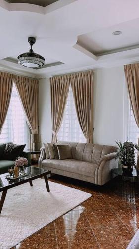 a living room with a couch and a table at Kamilia Homestay KB City Centre in Kota Bharu