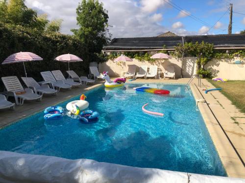 a swimming pool with some inflatable toys in it at La Vendange Family Gites in Gibourne
