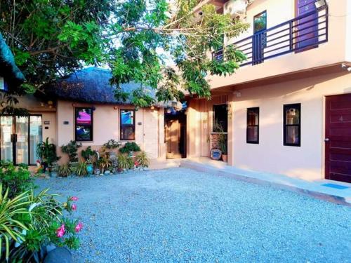 a house with a driveway in front of it at CRISTINA Beachfront Cottages in San Juan