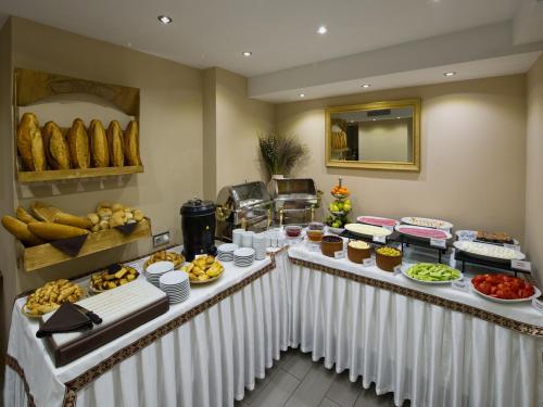 a buffet table filled with lots of different types of food at Hotel Olimpiyat in Istanbul