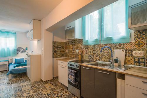 a kitchen with a sink and a stove top oven at ANGELS HOUSE in Skala Kallirakhis