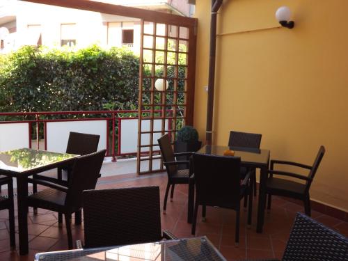 a restaurant with tables and chairs and a patio at Hotel Cristina in Chianciano Terme