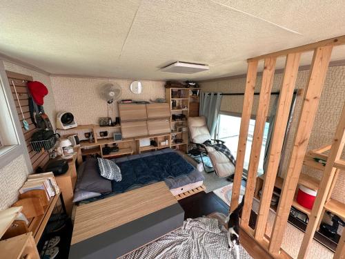 an aerial view of a room with a bed and shelves at Camp k in Mokpo