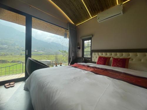 a bedroom with a large bed and a large window at Sapa Bamboo Eco in Sa Pa
