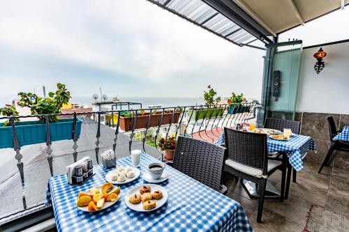 a table with plates of food on a balcony at Stanpoli Hostel in Istanbul