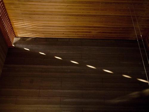 a wooden ceiling in a building with lights on it at Numazu Club in Numazu