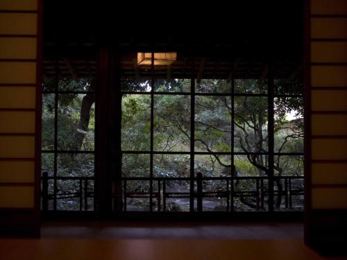 a window in a house looking out at trees at Numazu Club in Numazu