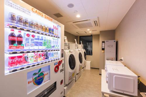 a laundry room with a washer and dryer at Sotetsu Fresa Inn Sapporo-Susukino in Sapporo