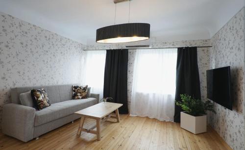 a living room with a couch and a table at Papli Beach Apartment in Pärnu