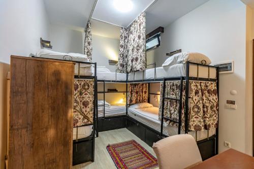 een kamer met 3 stapelbedden en een tafel bij Stanpoli Hostel in Istanbul