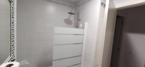 a white bathroom with a shower and a toilet at JT CHICLANA, ,Parking, Aire, Wifi, TV, Terraza in Chiclana de la Frontera