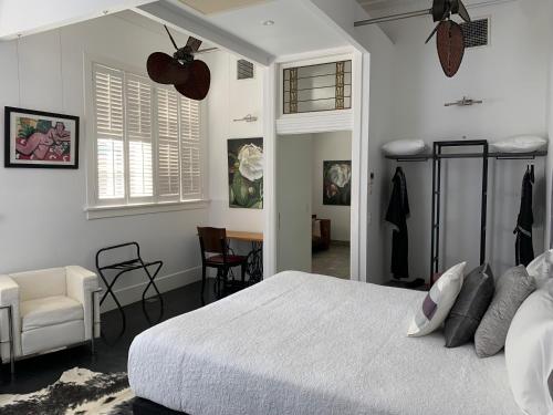 a bedroom with a bed and a chair and a table at CIRCA 1936 Art Hotel in Corowa