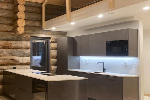 a kitchen with a sink and a counter top at Levi Ski IN Ski OUT Premium VillaWestWind B in Levi