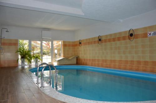 a large swimming pool in a building with a pool at B&B Landrynka in Krynica Morska