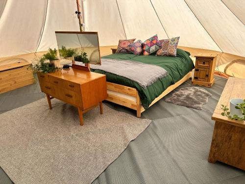 a bedroom with a bed in a tent at Walltree House Glamping in Brackley
